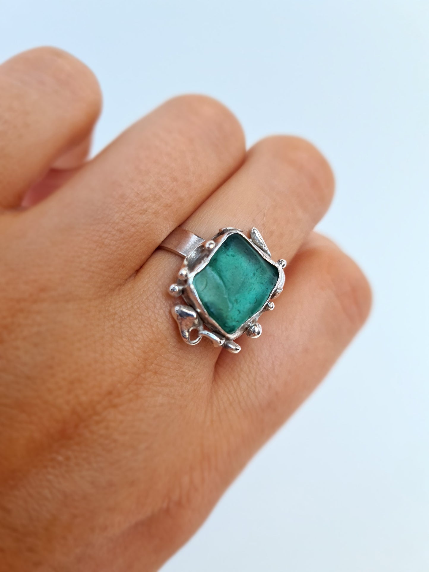 This unique ring is inspired by the organic shapes found in the sea. The captivating turquoise sea gem is nestled in a sterling silver bezel set upon a thick band. Crafted with sustainability in mind this handmade silver ring is made from 100% recycled silver.