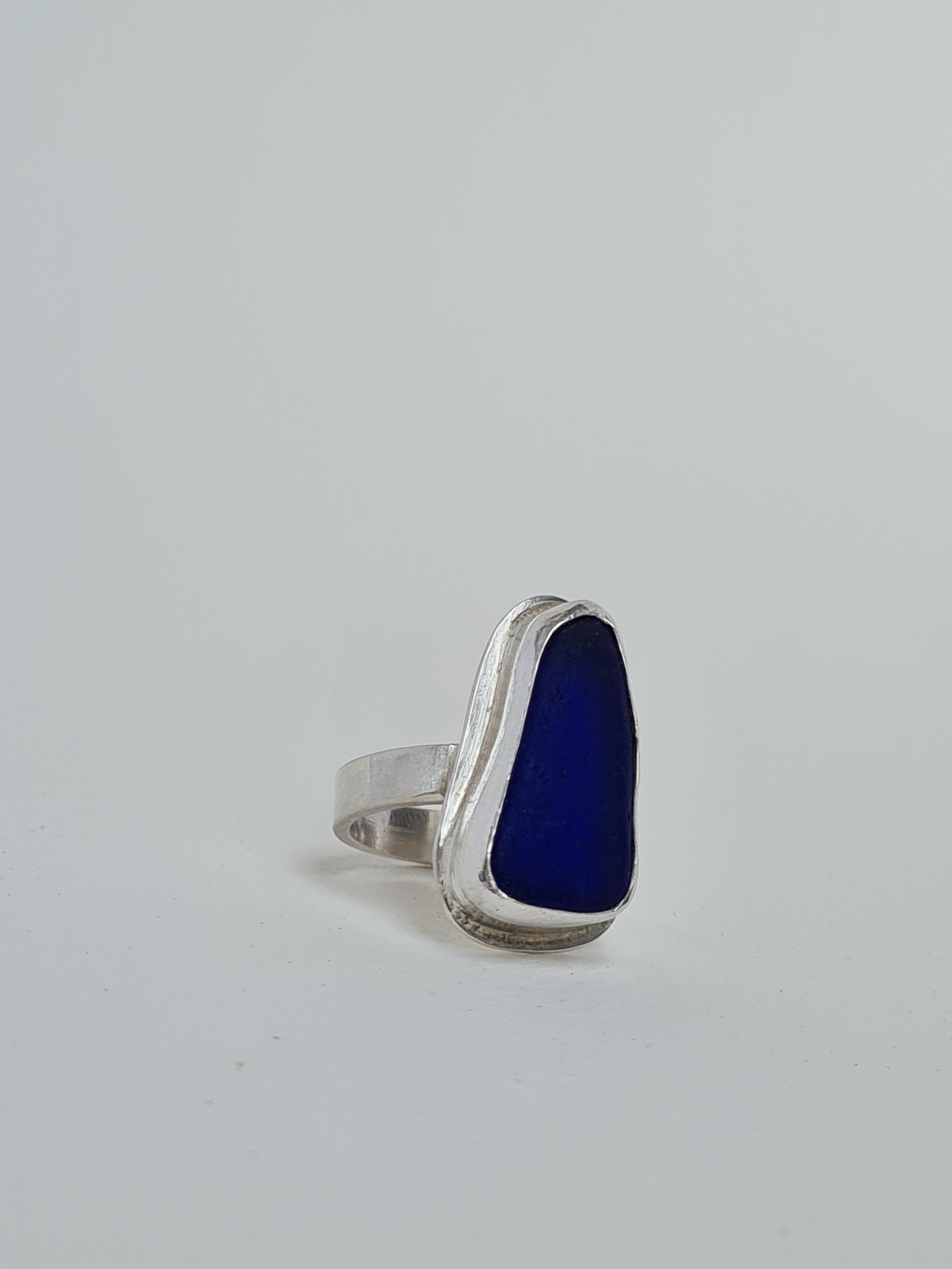 This rare and beautiful blue sea glass is cradled in a sterling silver bezel set upon a thick band. Made with sustainability in mind this handmade silver ring is made from 100% recycled silver.