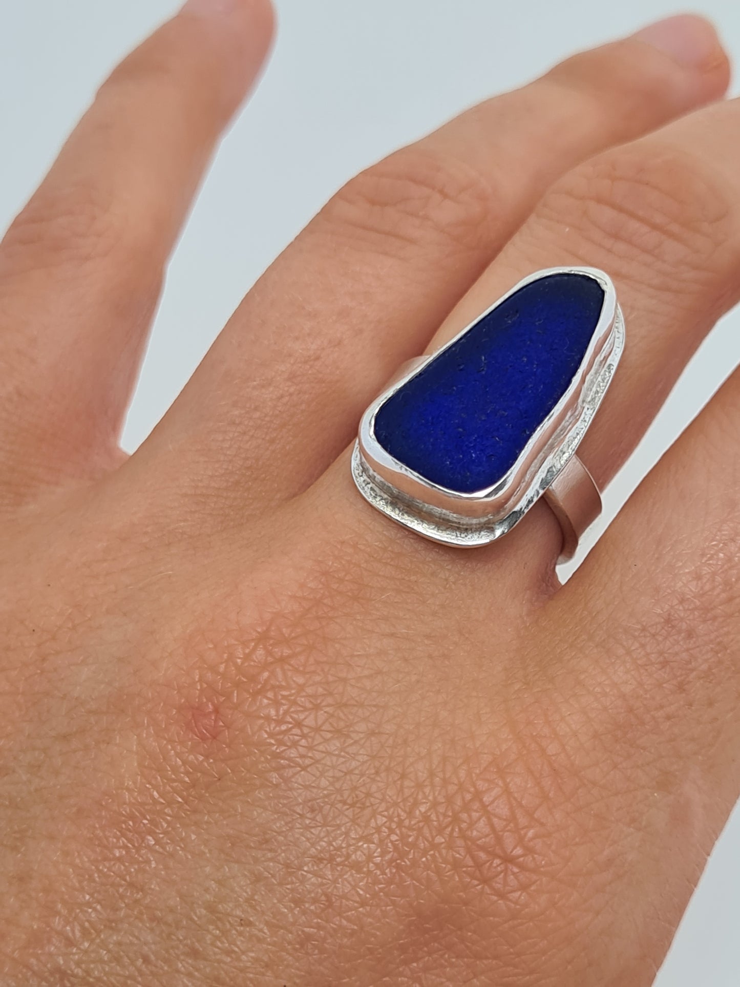 This rare and beautiful blue sea glass is cradled in a sterling silver bezel set upon a thick band. Made with sustainability in mind this handmade silver ring is made from 100% recycled silver.