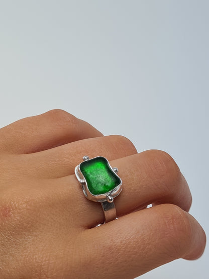 This vibrant green sea gem is nestled in a sterling silver bezel with subtle embellishments and set upon a thick band. Crafted with sustainability in mind this silver ring is handmade from 100% recycled silver.