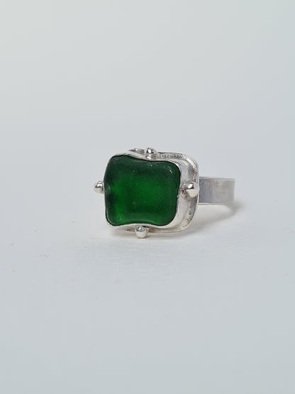 This vibrant green sea gem is nestled in a sterling silver bezel with subtle embellishments and set upon a thick band. Crafted with sustainability in mind this silver ring is handmade from 100% recycled silver.