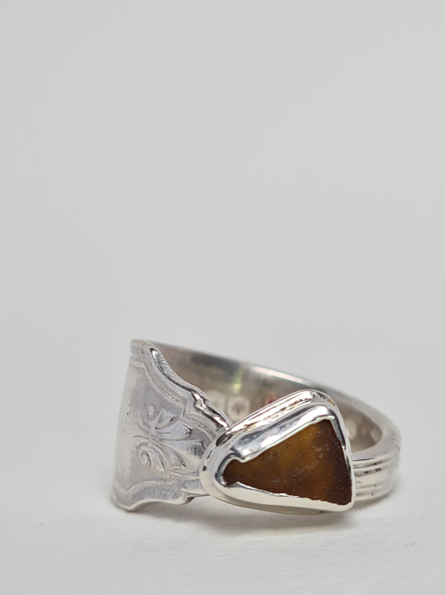 This beautiful amber sea gem is encased in a silver bezel set upon a reworked vintage sterling silver spoon with intricate details. Handmade with sustainability in mind this piece is made from 100% recycled silver.