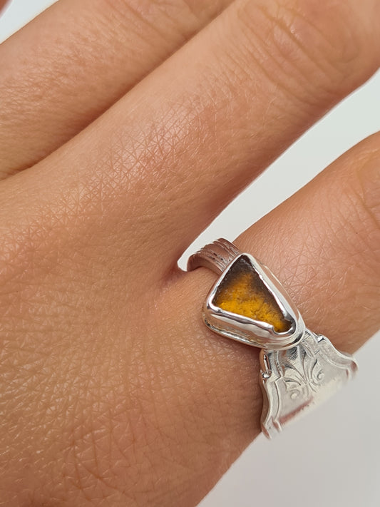 This beautiful amber sea gem is encased in a silver bezel set upon a reworked vintage sterling silver spoon with intricate details. Handmade with sustainability in mind this piece is made from 100% recycled silver.