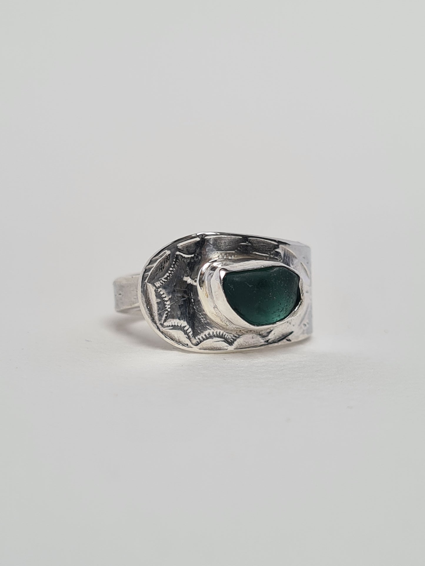 This beautiful teal sea gem is nestled in a silver bezel set upon a reworked vintage sterling silver spoon with intricate details. Crafted with sustainability in mind this silver ring is handmade from 100% recycled silver.