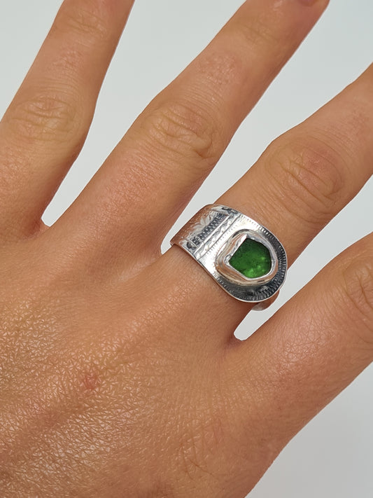 This vibrant green sea gem is cradled in a silver bezel set upon a reworked vintage sterling silver spoon with intricate details. Made with sustainability in mind this silver ring is handmade from 100% recycled silver.