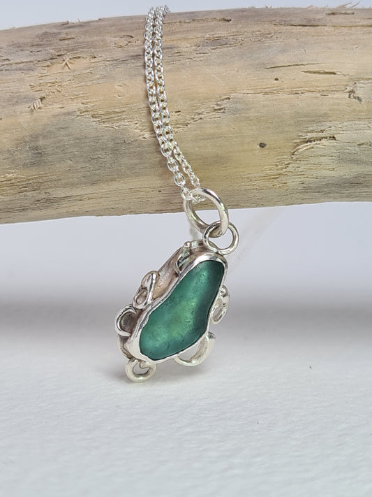 This unique pendant is inspired by the organic shapes found in the sea. The aquamarine sea gem is nestled in a sterling silver bezel on a delicate silver cable chain. Handmade with sustainability in mind this necklace is made from 100% recycled silver.