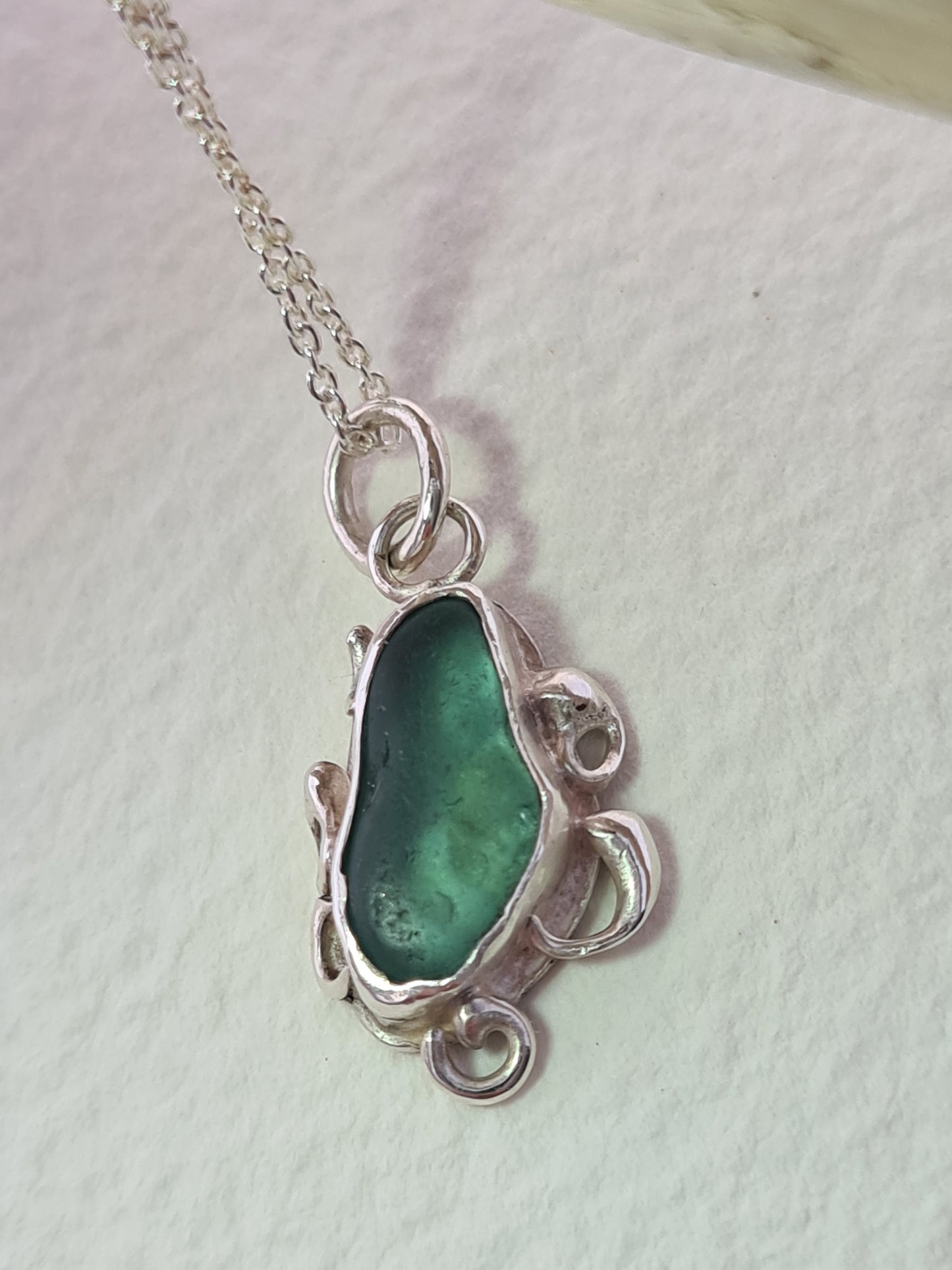 This unique pendant is inspired by the organic shapes found in the sea. The aquamarine sea gem is nestled in a sterling silver bezel on a delicate silver cable chain. Handmade with sustainability in mind this necklace is made from 100% recycled silver.