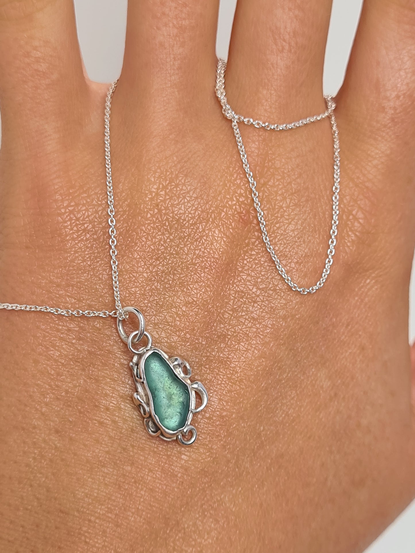 This unique pendant is inspired by the organic shapes found in the sea. The aquamarine sea gem is nestled in a sterling silver bezel on a delicate silver cable chain. Handmade with sustainability in mind this necklace is made from 100% recycled silver.