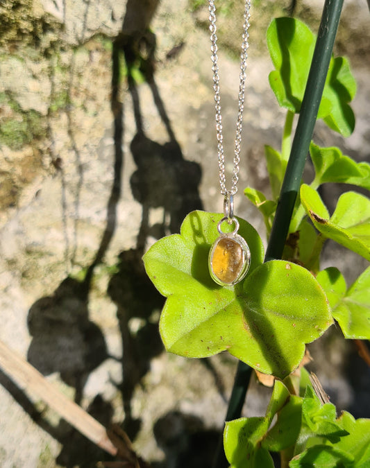 This rare yellow piece of sea glass is nestled in a sterling silver bezel on a delicate silver cable chain. Handmade with sustainability in mind this silver necklace is made from 100% recycled silver.  This piece of sea glass was found in West Cork, Ireland. A fragment of our beloved Irish coastline forever preserved in silver. 