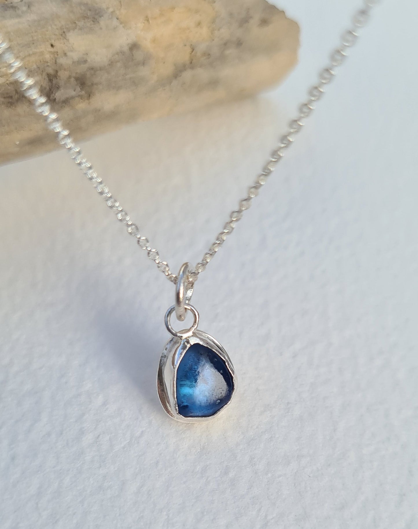 This bright little ocean blue piece of sea glass is nestled in a sterling silver bezel on a delicate silver cable chain. Handmade with sustainability in mind this silver necklace is made from 100% recycled silver.