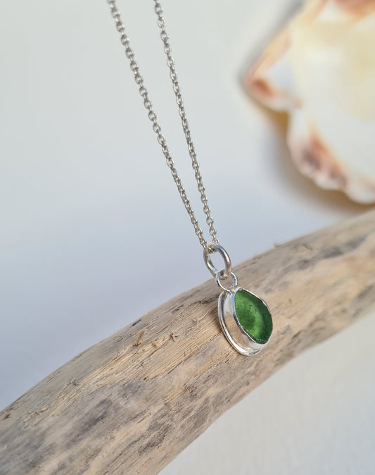 This bright little green piece of sea glass is nestled in a sterling silver bezel on a delicate silver cable chain. Handmade with sustainability in mind this silver necklace is made from 100% recycled silver.  This piece of sea glass was found in West Cork, Ireland. A fragment of our beloved Irish coastline forever preserved in silver. 