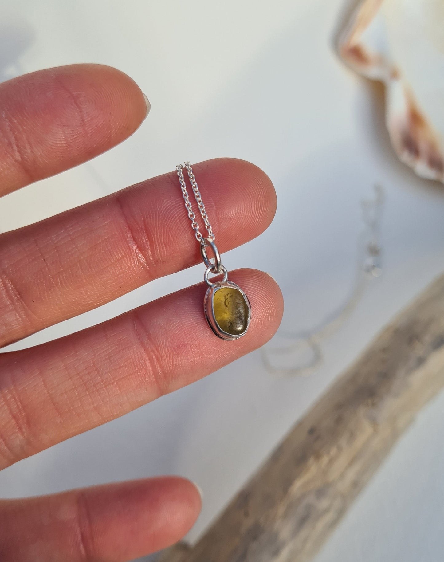 This rare yellow piece of sea glass is nestled in a sterling silver bezel on a delicate silver cable chain. Handmade with sustainability in mind this silver necklace is made from 100% recycled silver. This piece of sea glass was found in West Cork, Ireland. A fragment of our beloved Irish coastline forever preserved in silver.