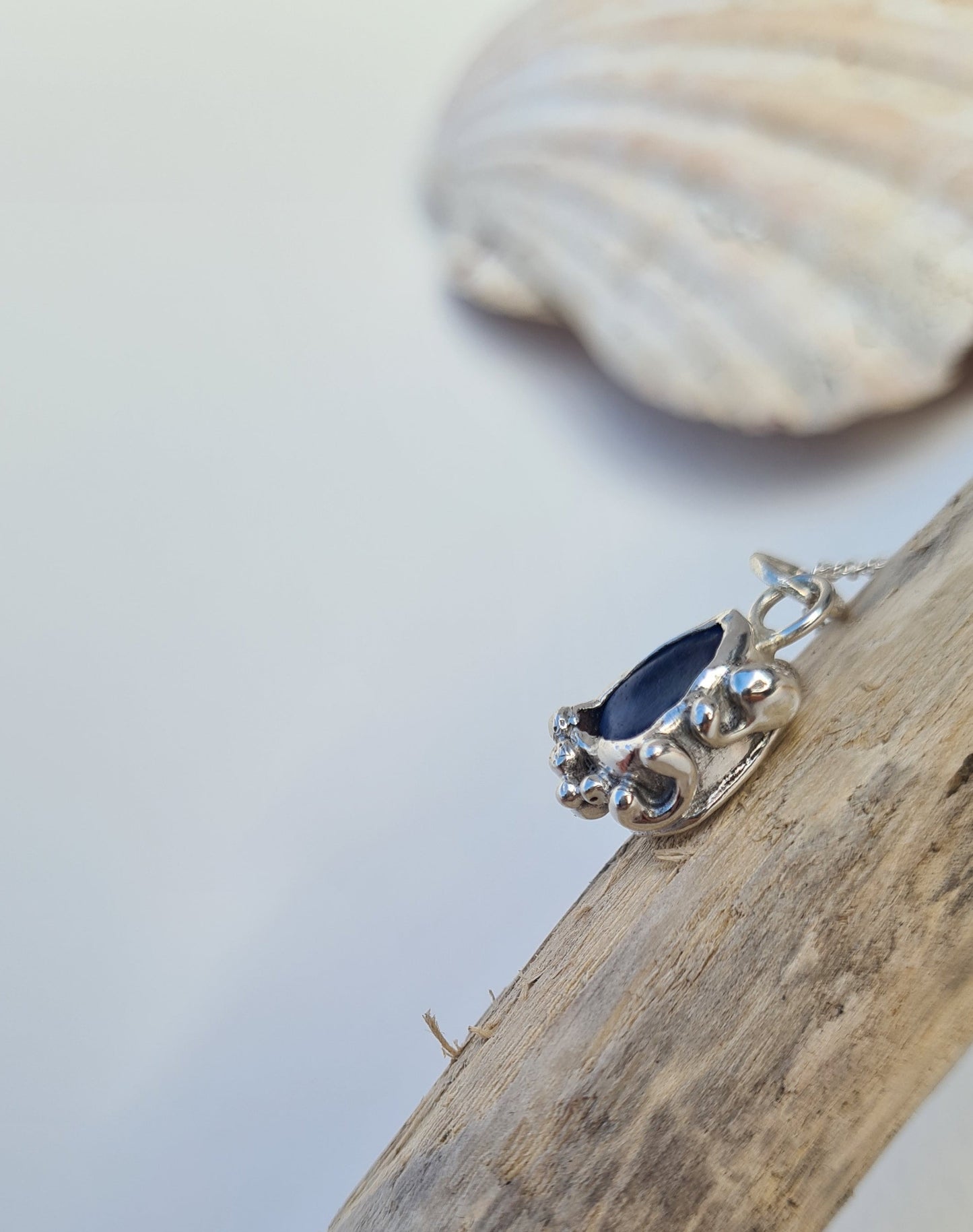 This unique pendant is inspired by the organic shapes created by the sea and the waves. The ocean blue sea glass is nestled in a sterling silver bezel on a delicate silver cable chain. Handmade with sustainability in mind this necklace is made from 100% recycled silver. This piece of sea glass was found in West Cork, Ireland. A fragment of our beloved Irish coastline forever preserved in silver.