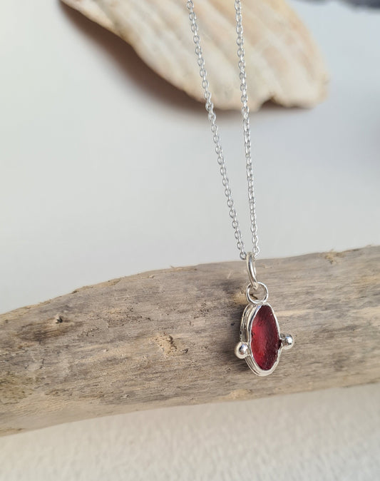 This extremely rare piece of pink sea glass is nestled in a sterling silver bezel on a delicate silver cable chain. Handmade with sustainability in mind this silver necklace is made from 100% recycled silver.  This piece of sea glass was found in West Cork, Ireland. A fragment of our beloved Irish coastline forever preserved in silver. 