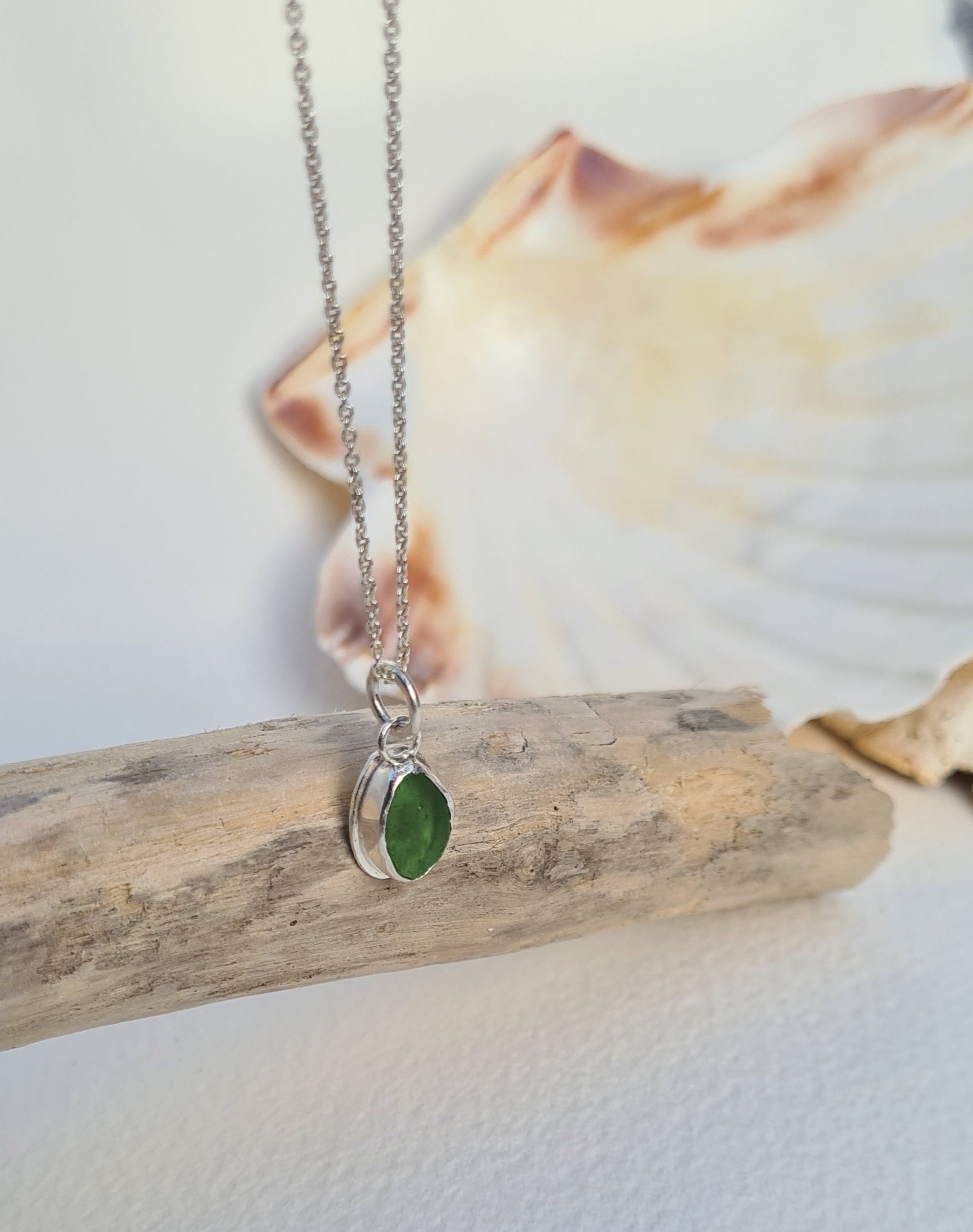 This bright little green piece of sea glass is nestled in a sterling silver bezel on a delicate silver cable chain. Handmade with sustainability in mind this silver necklace is made from 100% recycled silver.  This piece of sea glass was found in West Cork, Ireland. A fragment of our beloved Irish coastline forever preserved in silver. 