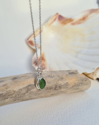 This bright little green piece of sea glass is nestled in a sterling silver bezel on a delicate silver cable chain. Handmade with sustainability in mind this silver necklace is made from 100% recycled silver.  This piece of sea glass was found in West Cork, Ireland. A fragment of our beloved Irish coastline forever preserved in silver. 