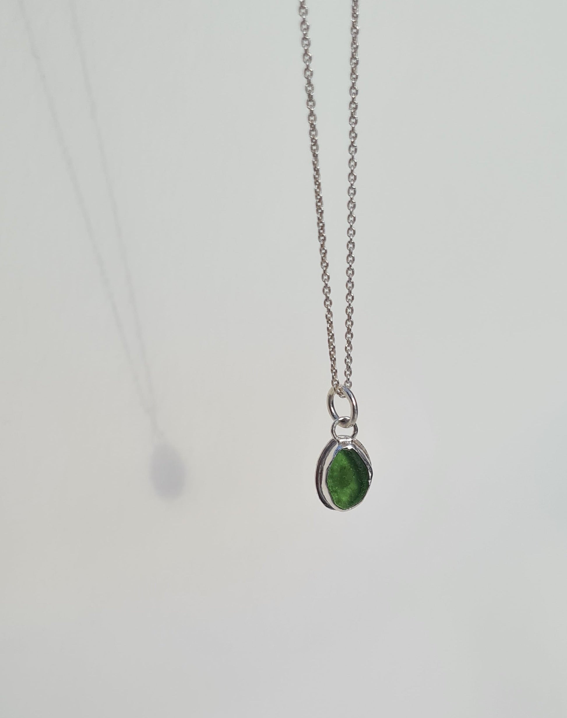 This bright little green piece of sea glass is nestled in a sterling silver bezel on a delicate silver cable chain. Handmade with sustainability in mind this silver necklace is made from 100% recycled silver.  This piece of sea glass was found in West Cork, Ireland. A fragment of our beloved Irish coastline forever preserved in silver. 