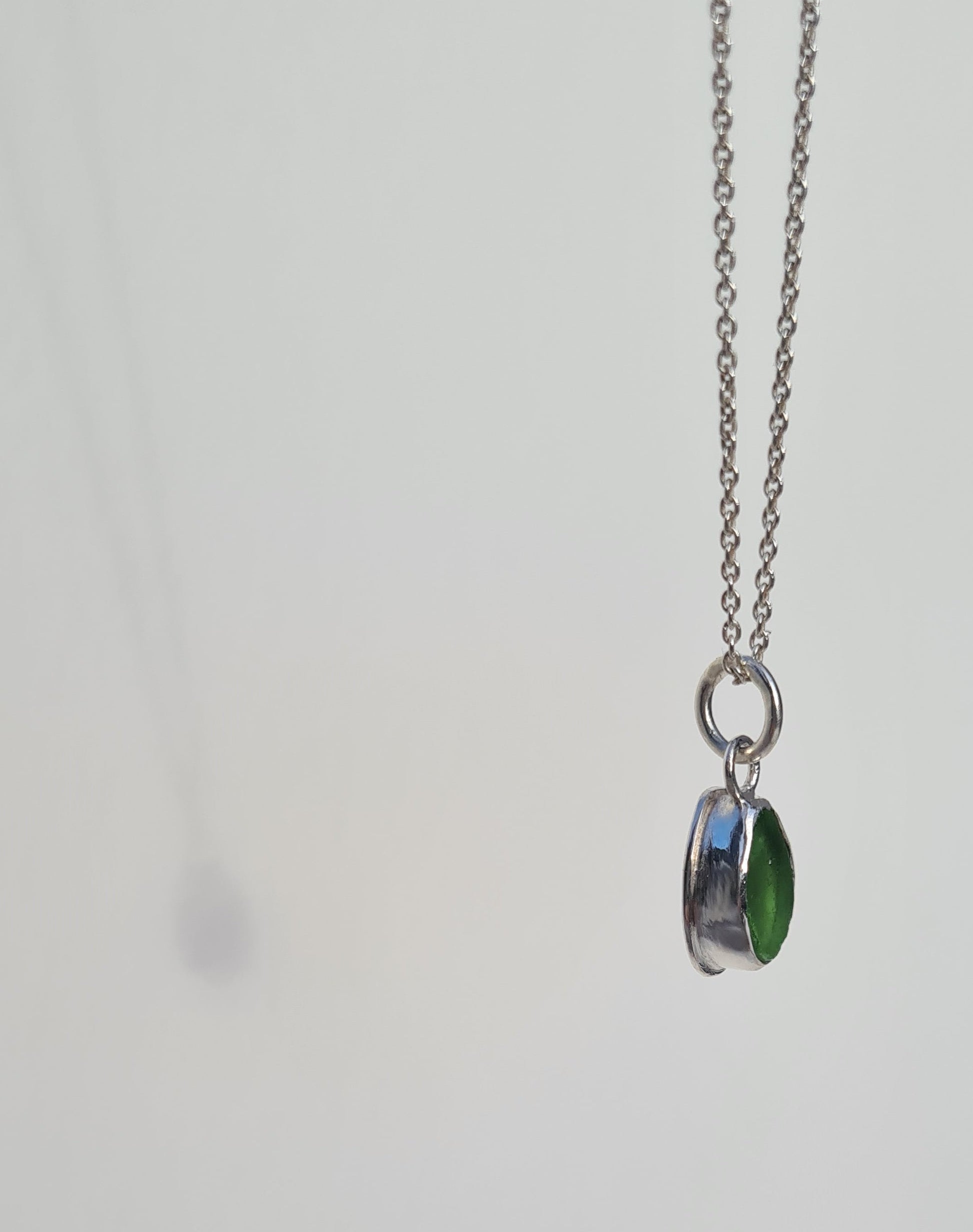 This bright little green piece of sea glass is nestled in a sterling silver bezel on a delicate silver cable chain. Handmade with sustainability in mind this silver necklace is made from 100% recycled silver.  This piece of sea glass was found in West Cork, Ireland. A fragment of our beloved Irish coastline forever preserved in silver. 
