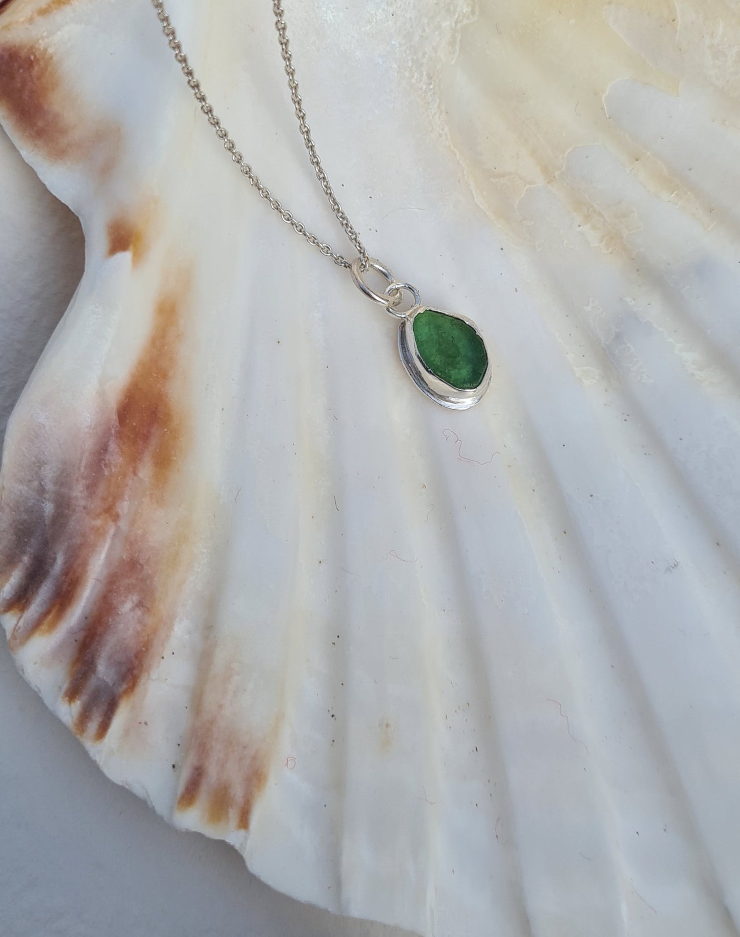 This bright little green piece of sea glass is nestled in a sterling silver bezel on a delicate silver cable chain. Handmade with sustainability in mind this silver necklace is made from 100% recycled silver.  This piece of sea glass was found in West Cork, Ireland. A fragment of our beloved Irish coastline forever preserved in silver. 