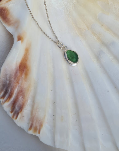 This bright little green piece of sea glass is nestled in a sterling silver bezel on a delicate silver cable chain. Handmade with sustainability in mind this silver necklace is made from 100% recycled silver.  This piece of sea glass was found in West Cork, Ireland. A fragment of our beloved Irish coastline forever preserved in silver. 